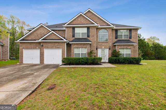 view of front of home with a front yard and a garage