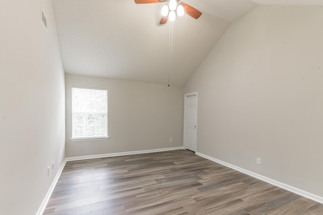 unfurnished room featuring ceiling fan, dark wood-type flooring, and vaulted ceiling