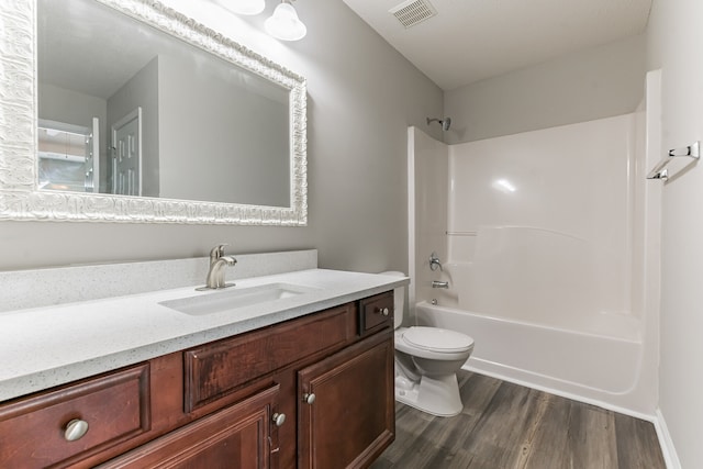 full bathroom featuring vanity, toilet, wood-type flooring, and shower / tub combination