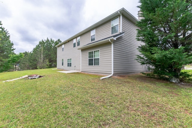 rear view of house featuring a yard