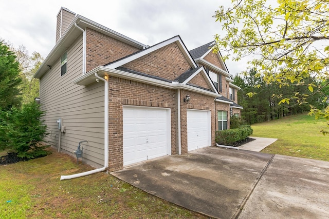 view of home's exterior with a lawn and a garage