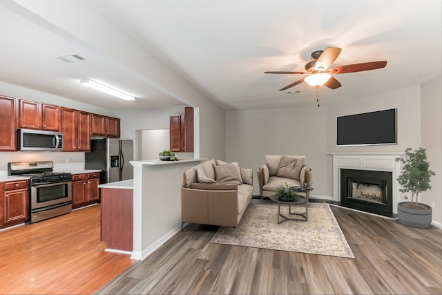 living room featuring hardwood / wood-style flooring and ceiling fan