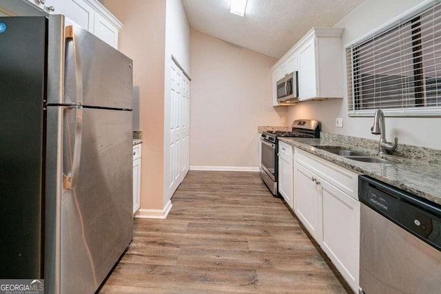 kitchen featuring sink, white cabinets, and stainless steel appliances