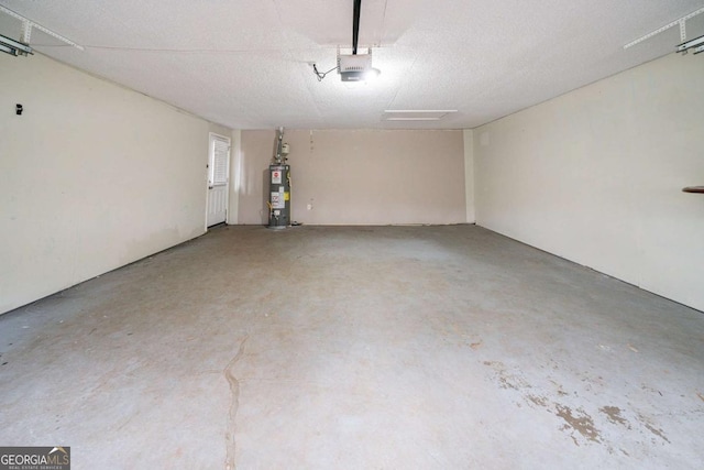 garage featuring gas water heater and a garage door opener