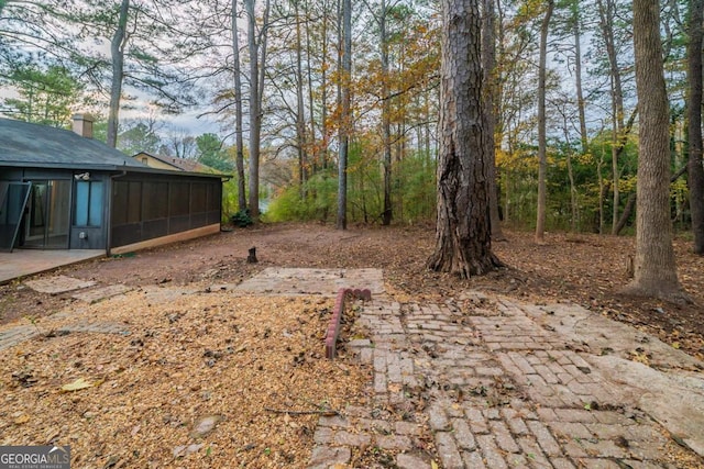 view of yard featuring a patio and a sunroom