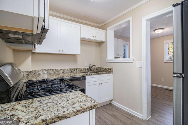 kitchen with white cabinetry, sink, stainless steel appliances, crown molding, and light wood-type flooring