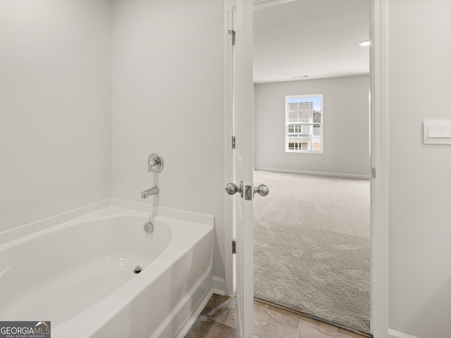 bathroom with a tub to relax in