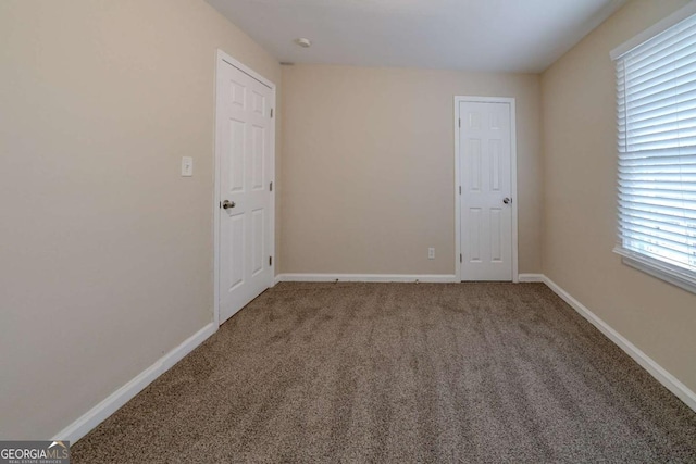 spare room with carpet and a healthy amount of sunlight