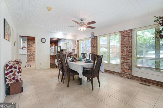 dining area featuring ceiling fan, light tile patterned flooring, and wooden ceiling