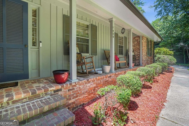 view of exterior entry featuring a porch