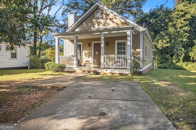 bungalow-style house featuring a porch and a front yard