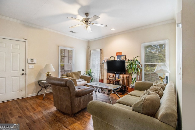 living room featuring ornamental molding, dark wood-type flooring, and ceiling fan