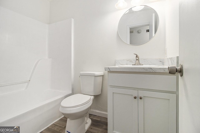 bathroom with hardwood / wood-style floors, vanity, and toilet