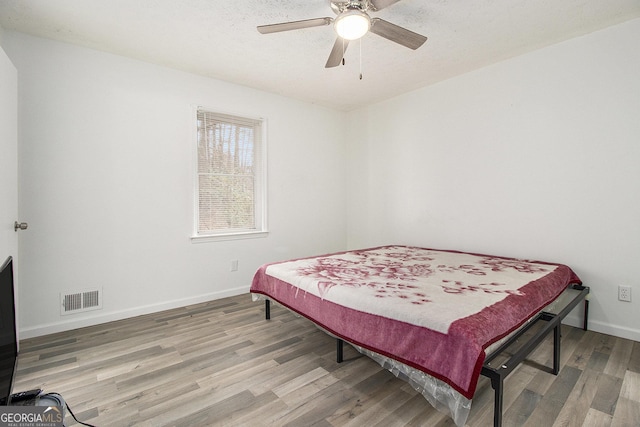 bedroom featuring hardwood / wood-style floors and ceiling fan