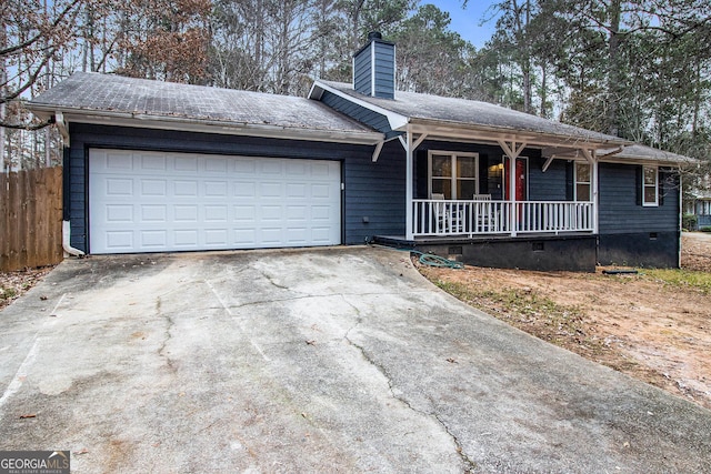 ranch-style house featuring covered porch and a garage