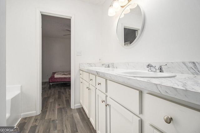 bathroom with a bathtub, hardwood / wood-style floors, and vanity