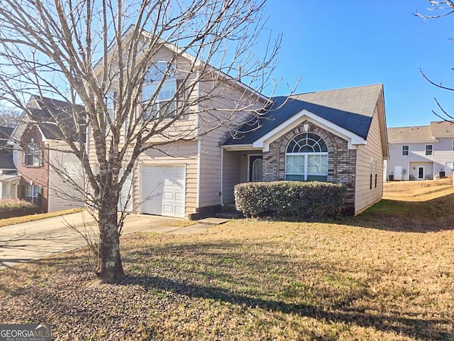 front facade with a front yard and a garage