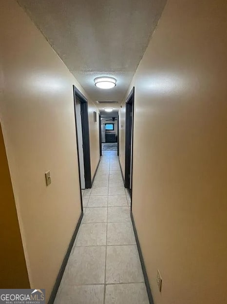 hall with light tile patterned floors