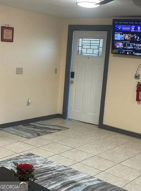 foyer featuring light tile patterned floors