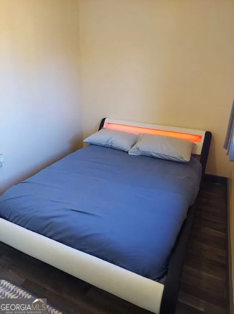 bedroom featuring dark hardwood / wood-style flooring