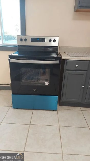 interior details featuring stainless steel range with electric stovetop and gray cabinets