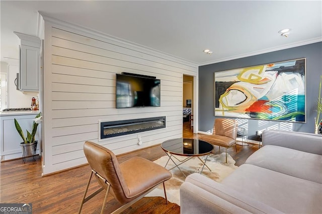 living room with hardwood / wood-style floors and ornamental molding