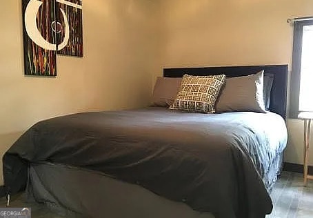 bedroom with hardwood / wood-style floors