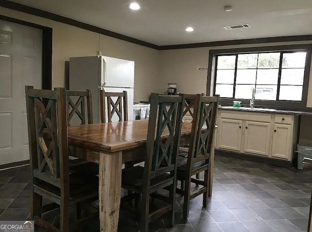 dining area featuring ornamental molding and sink