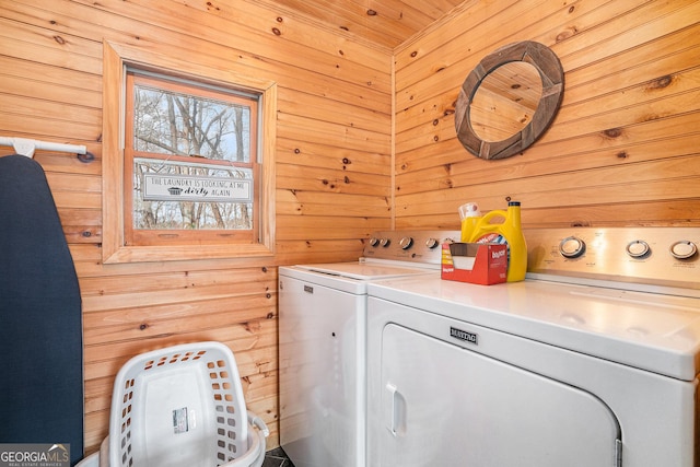 laundry room with washing machine and dryer, wooden walls, and wood ceiling