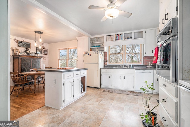 kitchen featuring white cabinets, white appliances, and light hardwood / wood-style flooring