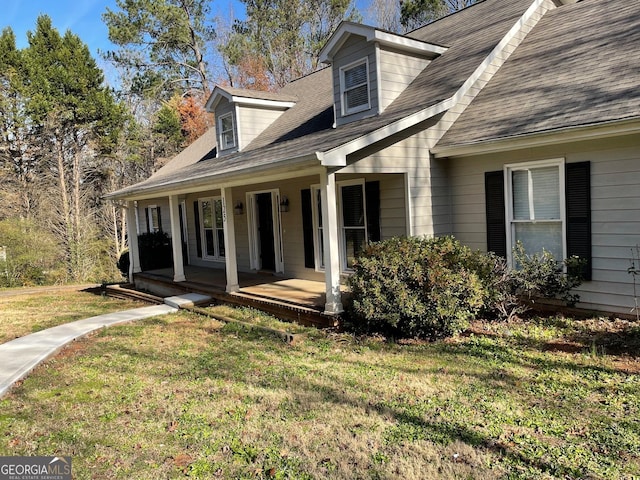 view of front of house with a front yard and a porch