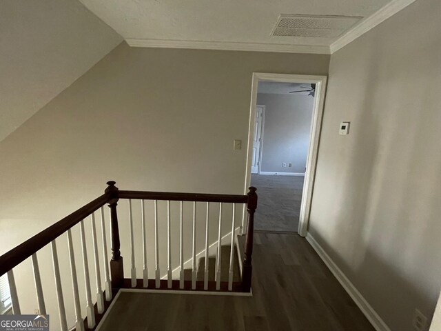 stairs with hardwood / wood-style flooring and ornamental molding