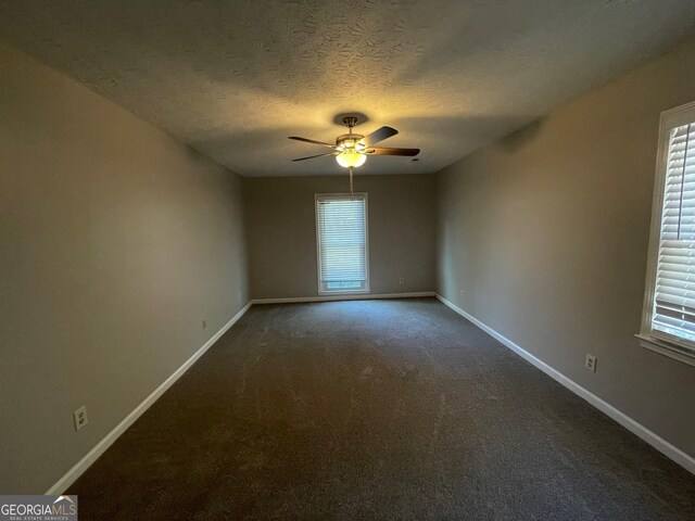 unfurnished room with carpet flooring, ceiling fan, and a textured ceiling