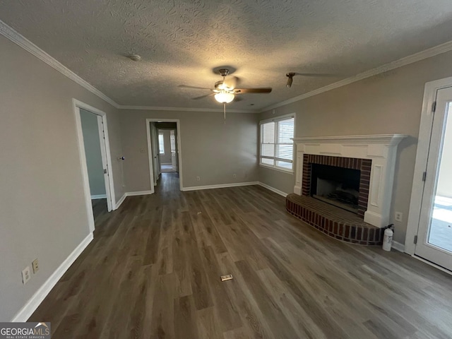 unfurnished living room featuring a textured ceiling, crown molding, dark hardwood / wood-style flooring, and a fireplace