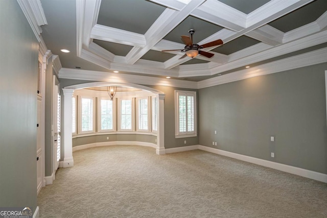 carpeted empty room featuring ornamental molding, a healthy amount of sunlight, and coffered ceiling