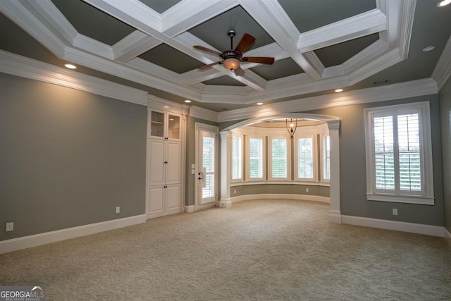 spare room featuring ceiling fan, carpet floors, crown molding, and coffered ceiling