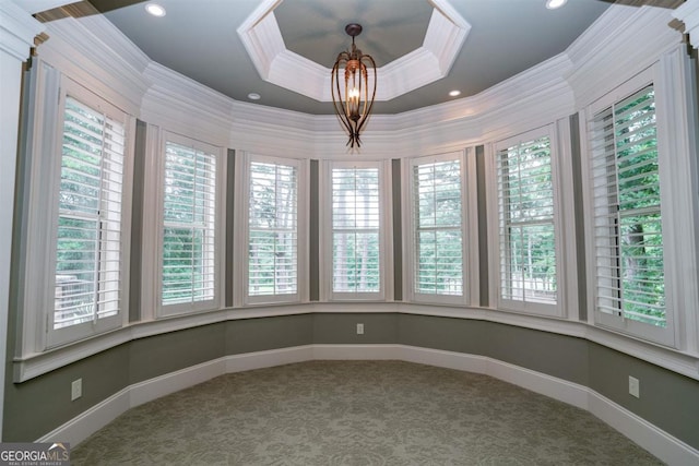 unfurnished sunroom with a raised ceiling and a chandelier