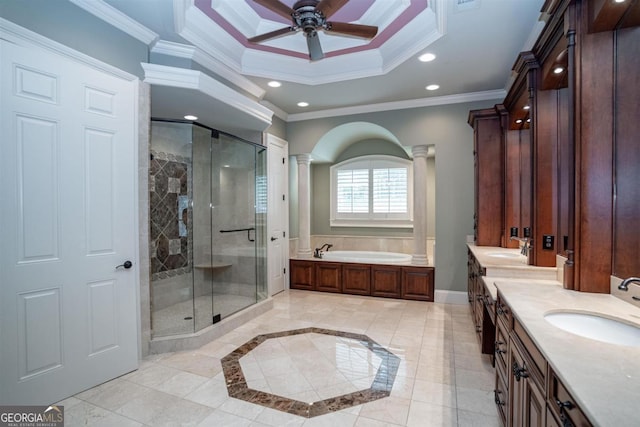 bathroom with vanity, crown molding, ceiling fan, separate shower and tub, and ornate columns