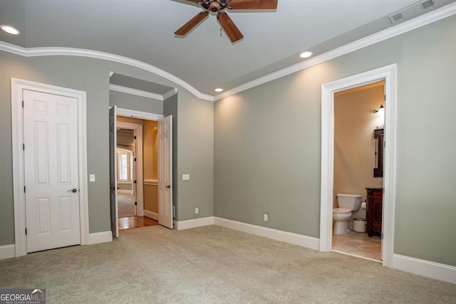 unfurnished bedroom featuring ensuite bathroom, ceiling fan, and ornamental molding