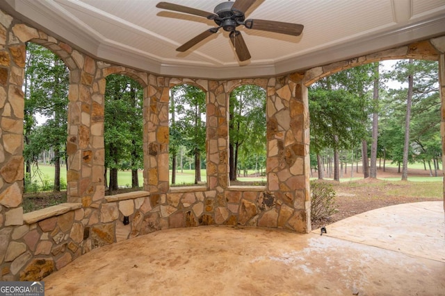 unfurnished sunroom with ceiling fan