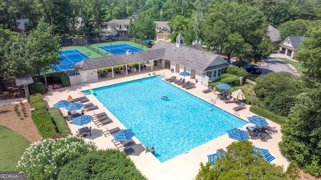 view of pool with tennis court