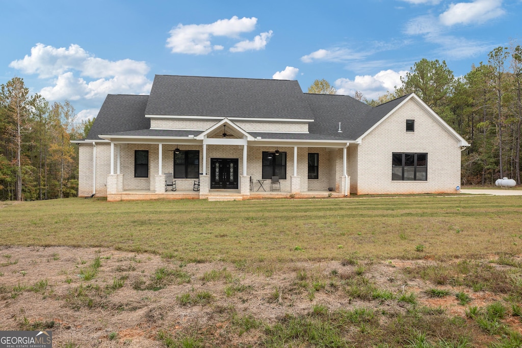 view of front of house with a porch and a front yard