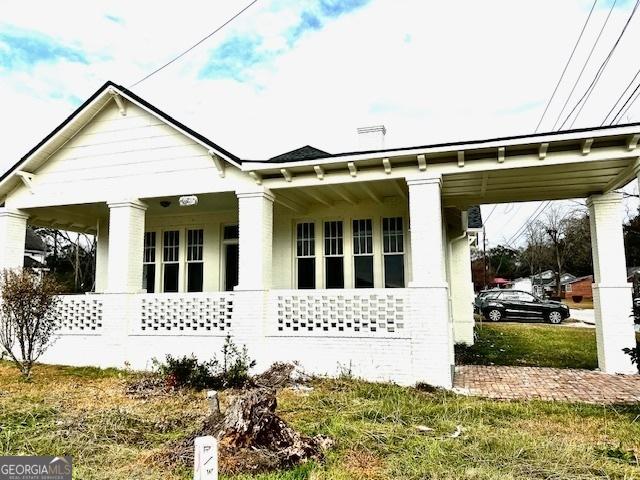 back of property featuring a porch