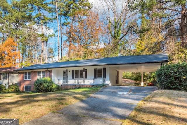 ranch-style house with a porch, a carport, and a front lawn