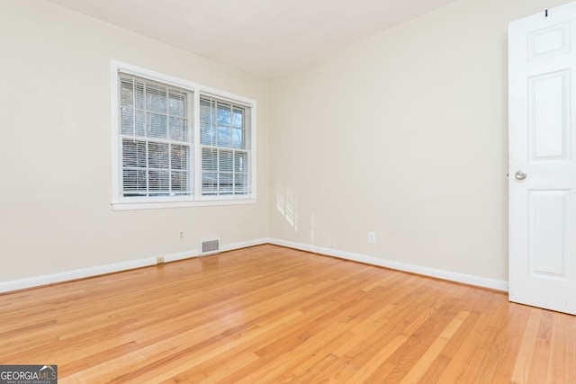 spare room featuring light hardwood / wood-style flooring