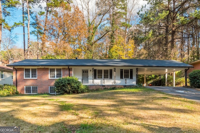 view of front of home with a front yard, central air condition unit, a carport, and covered porch