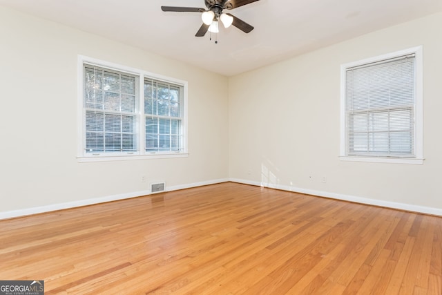 empty room with light hardwood / wood-style flooring and ceiling fan