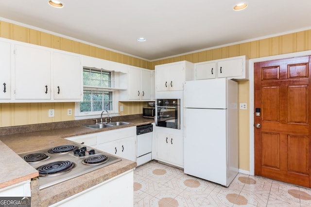 kitchen with appliances with stainless steel finishes, white cabinetry, ornamental molding, and sink