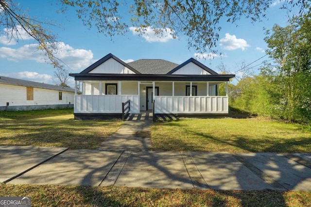 view of front of house with covered porch and a front lawn