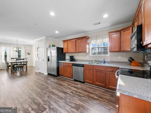 kitchen with dark wood-type flooring, stainless steel appliances, a healthy amount of sunlight, and sink